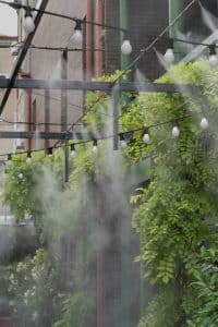 Water spray system to create a humidifier and cooling climate to reduce hot weather for plants