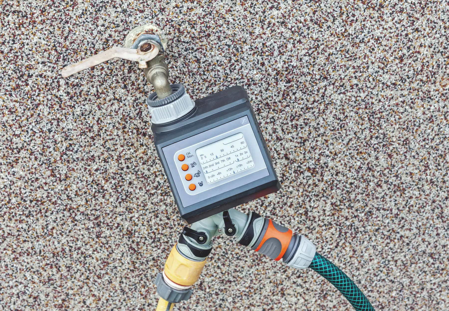 Watering timer with a digital display fitted to an outdoor faucet and hose